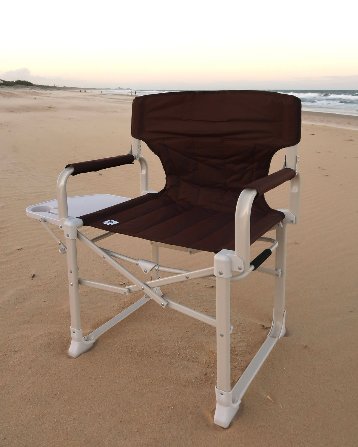 Outback Directors camp chair on the sand at sunset