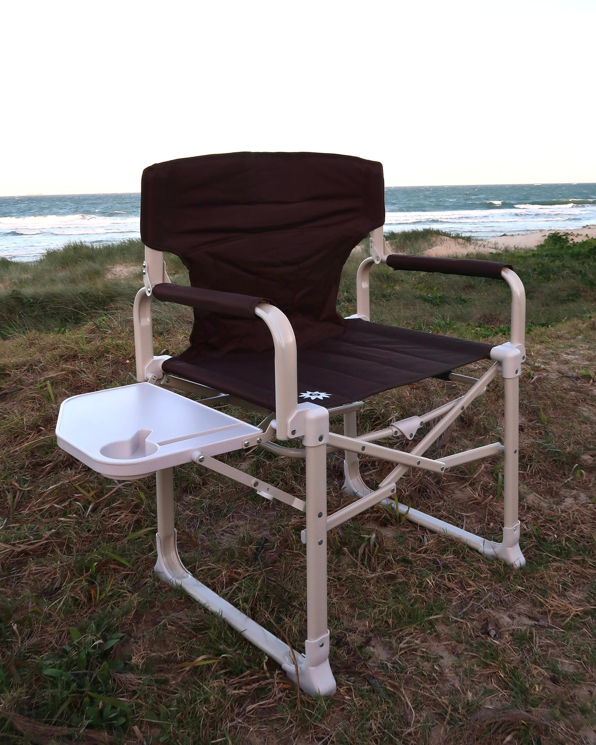 Outback Directors camp chair set up on the beach with side table out